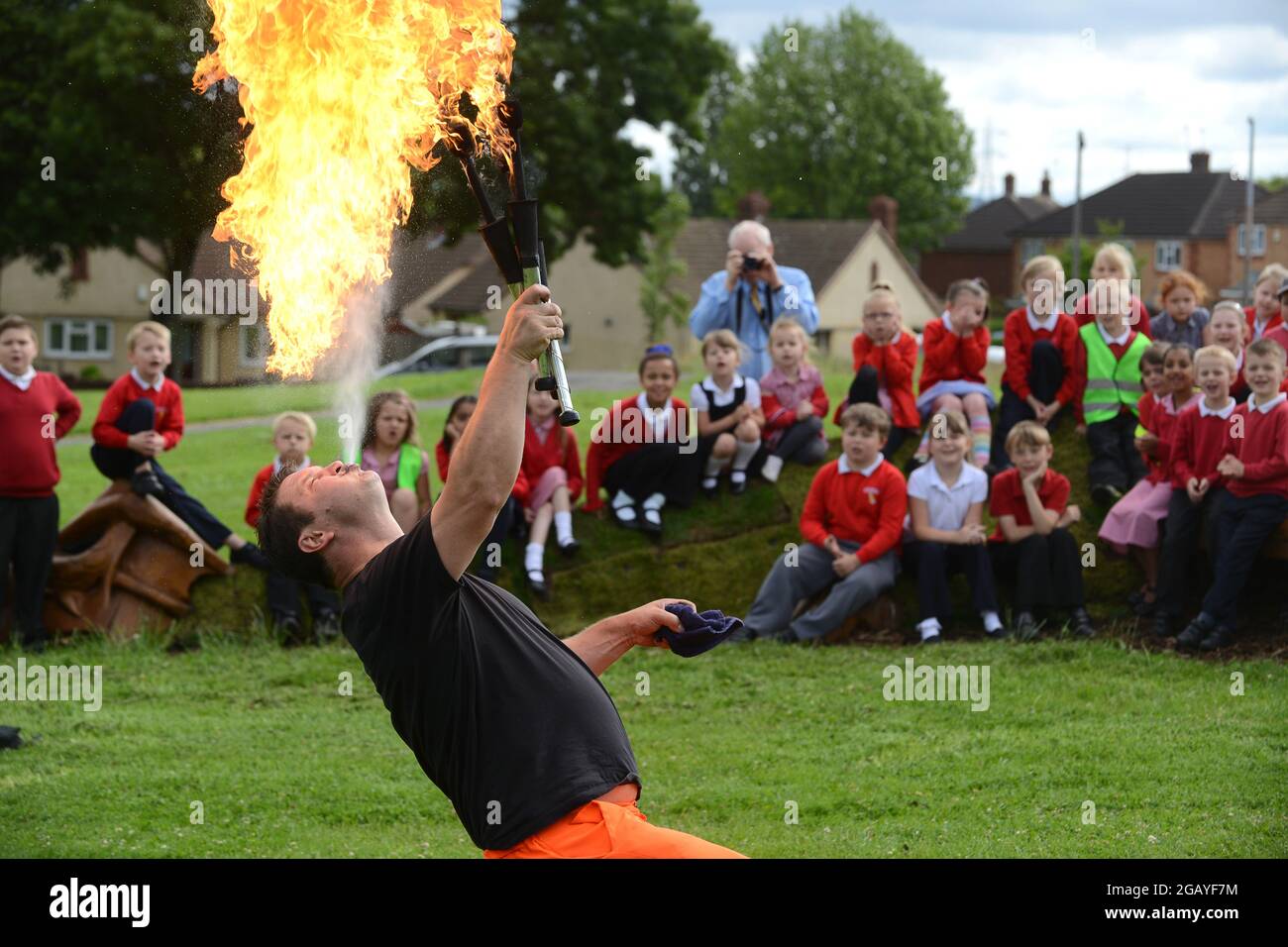 Fire eater entertaining school children in West Bromwich, Sandwell, Uk Stock Photo