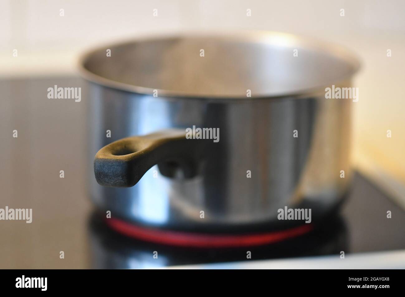Photo of a pot on stove in kitchen Stock Photo