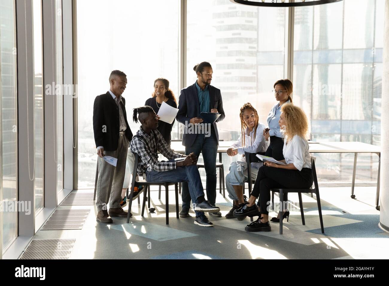 Young male african leader coaching diverse colleagues. Stock Photo
