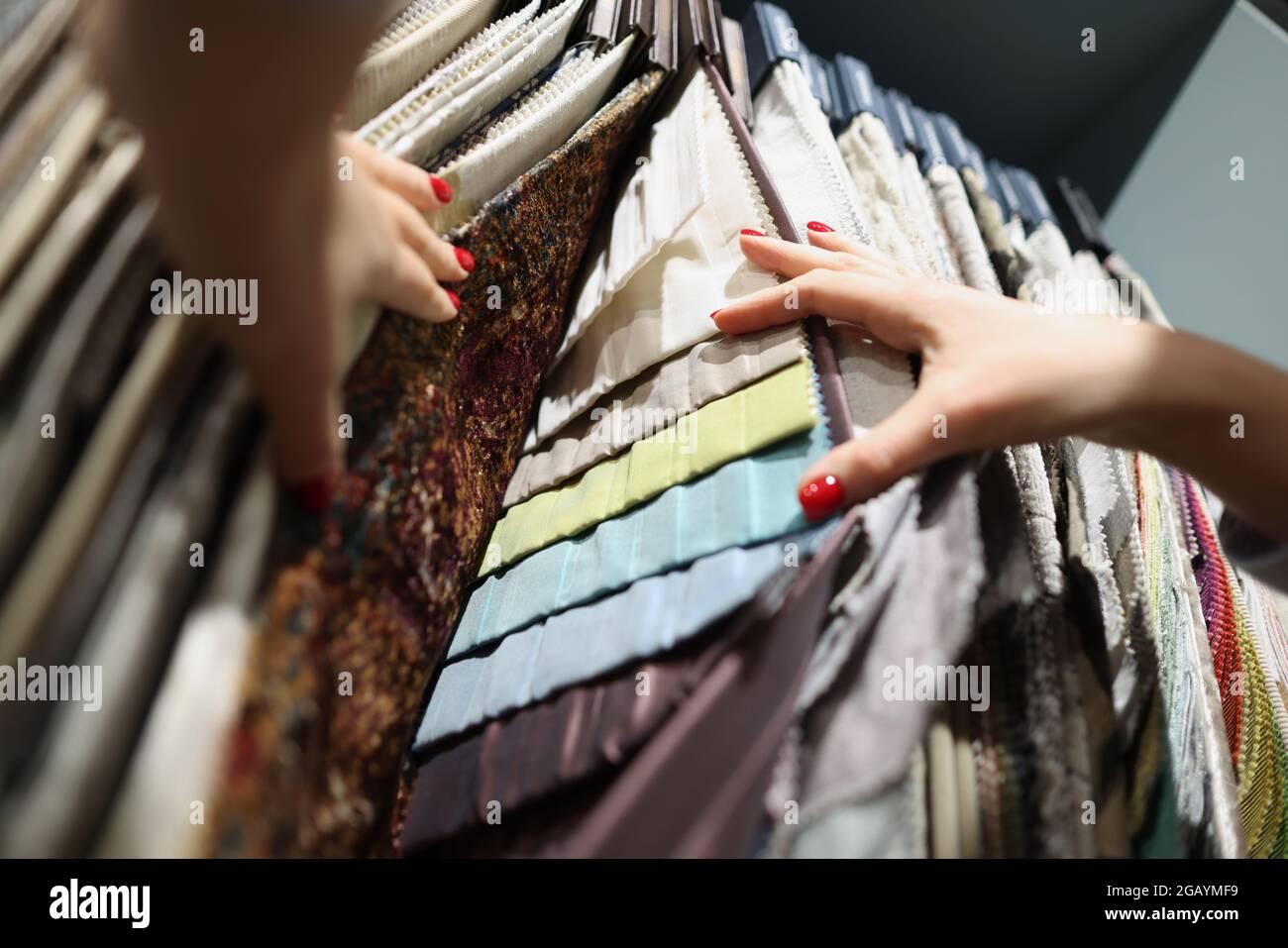 Multi-colored fabrics on exhibition stand in store Stock Photo
