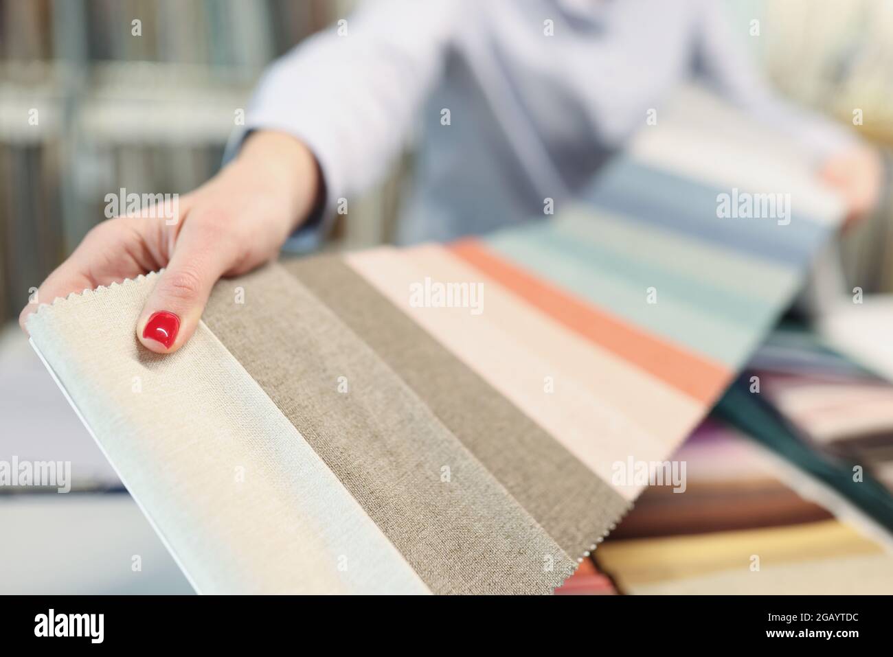 Colorful fabric catalog on seamstress or dressmaker work table Stock Photo