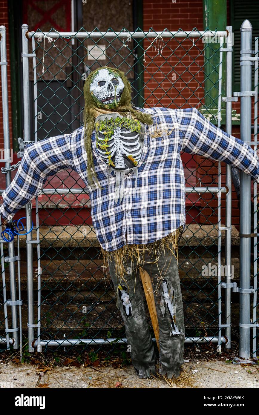 Straw man handing on a fence for Halloween Stock Photo
