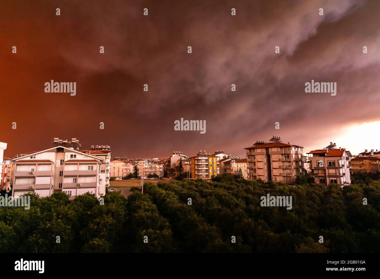 forest fire in Antalya, Manavgat Turkey, fumes, smokes in the city, fire planes and helicopters trying to put out the fire. Stock Photo