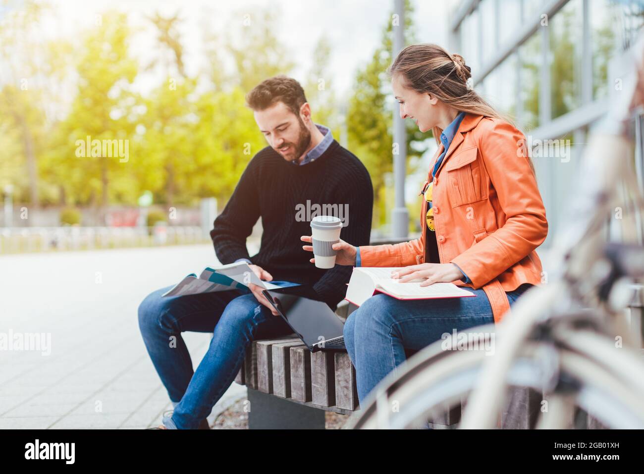 Man and woman student chatting on university campus Stock Photo - Alamy