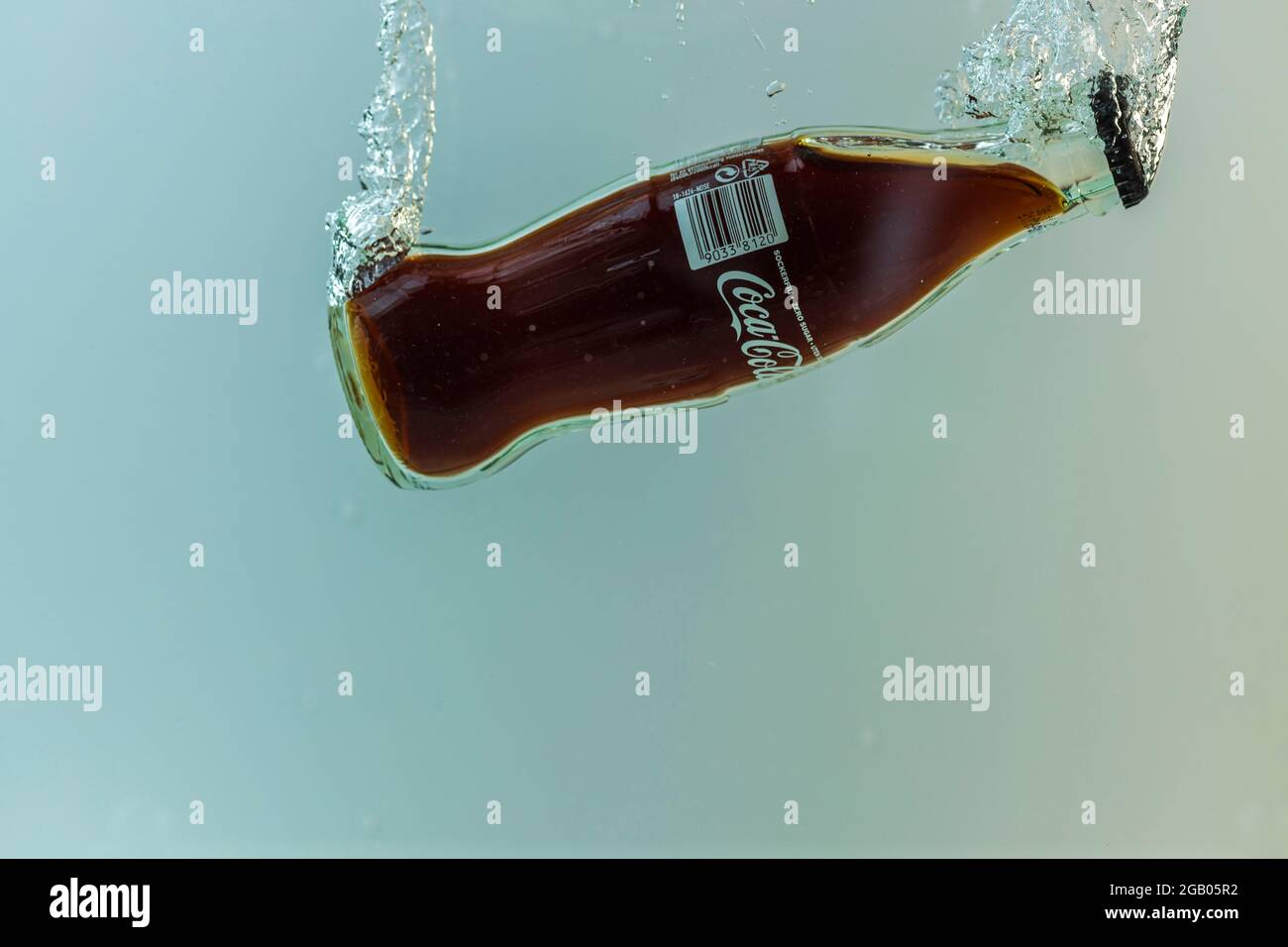 Close up view of Coca cola bottle falling in water Stock Photo Alamy