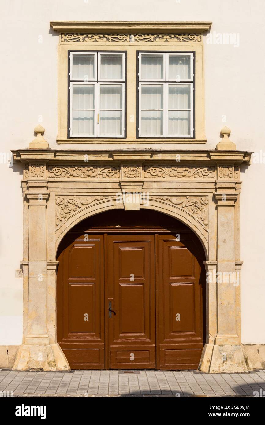 Baroque ornate stone-framed arched gate with year 1648, Sopron, Hungary Stock Photo