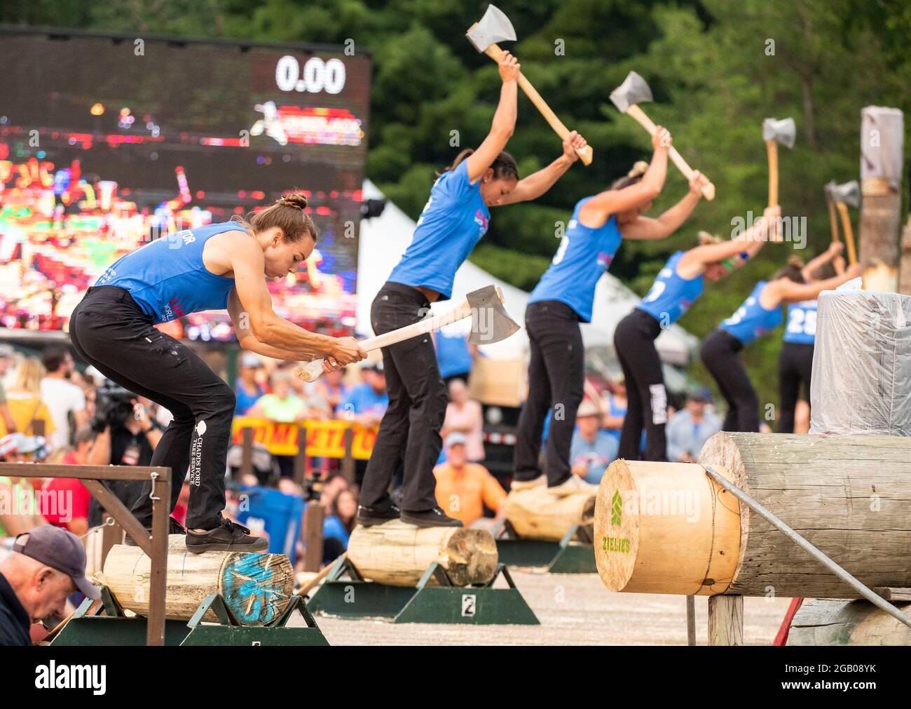 Hayward, USA. 1st Aug, 2021. Competitors use axes to chop wood during the 61st Lumberjack World Championships in Hayward, Wisconsin, the United States, on July 31, 2021. The championships held here showcased lumberjacks and lumberjills competing in sawing, chopping, speed climbing, log rolling, and boom-running. Credit: Joel Lerner/Xinhua/Alamy Live News Stock Photo
