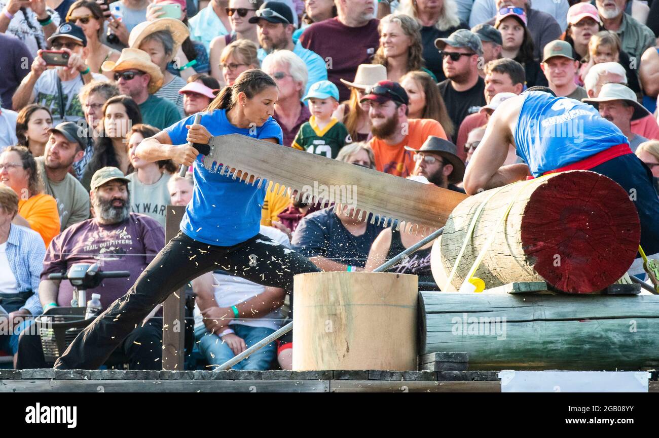 Hayward, USA. 1st Aug, 2021. A woman uses a crosscut saw to cut wood during the 61st Lumberjack World Championships in Hayward, Wisconsin, the United States, on July 31, 2021. The championships held here showcased lumberjacks and lumberjills competing in sawing, chopping, speed climbing, log rolling, and boom-running. Credit: Joel Lerner/Xinhua/Alamy Live News Stock Photo