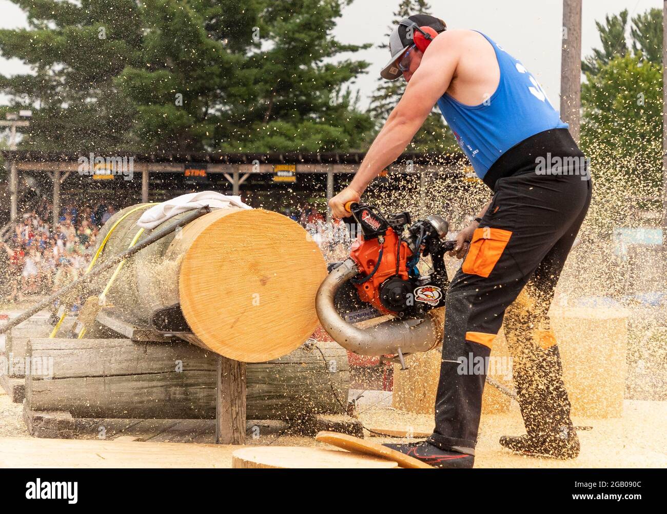 Hayward, USA. 1st Aug, 2021. A man uses a hot saw to cut wood during the 61st Lumberjack World Championships in Hayward, Wisconsin, the United States, on July 31, 2021. The championships held here showcased lumberjacks and lumberjills competing in sawing, chopping, speed climbing, log rolling, and boom-running. Credit: Joel Lerner/Xinhua/Alamy Live News Stock Photo