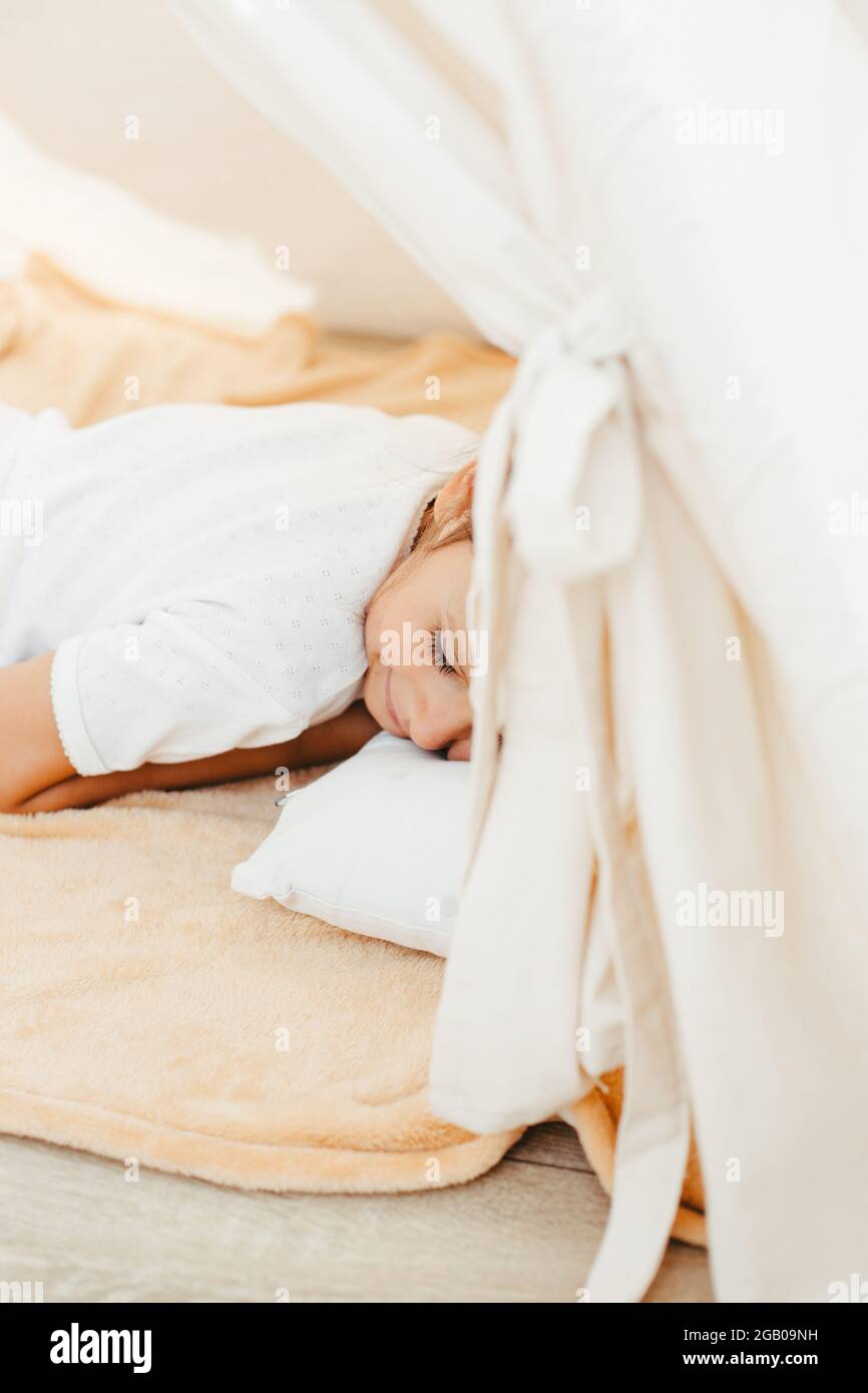 cute girl playing in teepee at home Stock Photo - Alamy