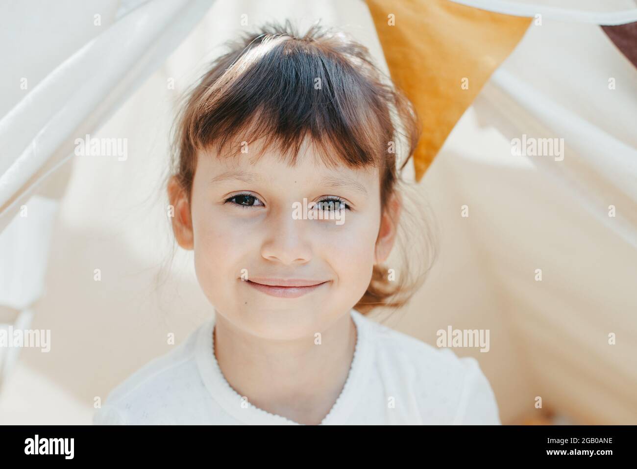 cute girl playing in teepee at home Stock Photo - Alamy