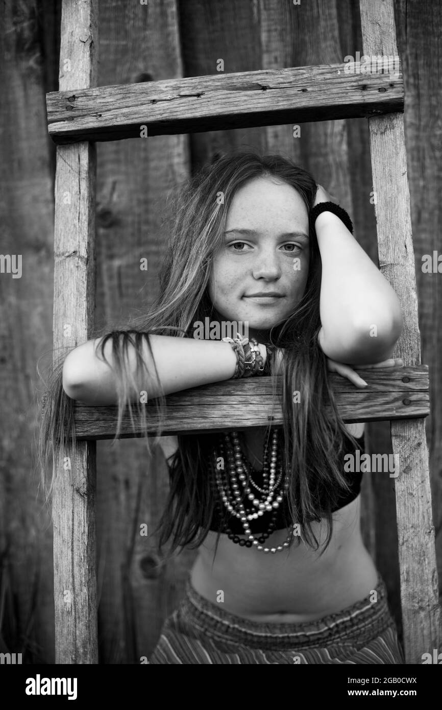 Cute girl portrait with hippie jewelry in rural surroundings. Black and white photo. Stock Photo
