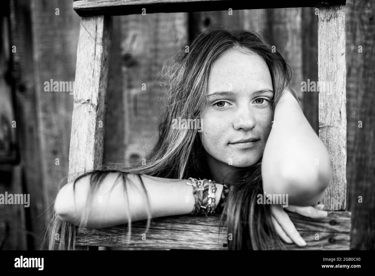 Cute girl portrait with hippie jewelry in rural surroundings, close-up. Black and white photo. Stock Photo