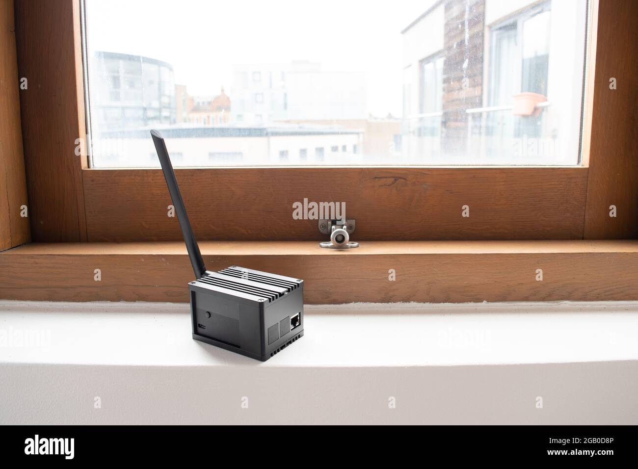 Helium hotspot cryptocurrency miner next to a window in a home Stock Photo  - Alamy