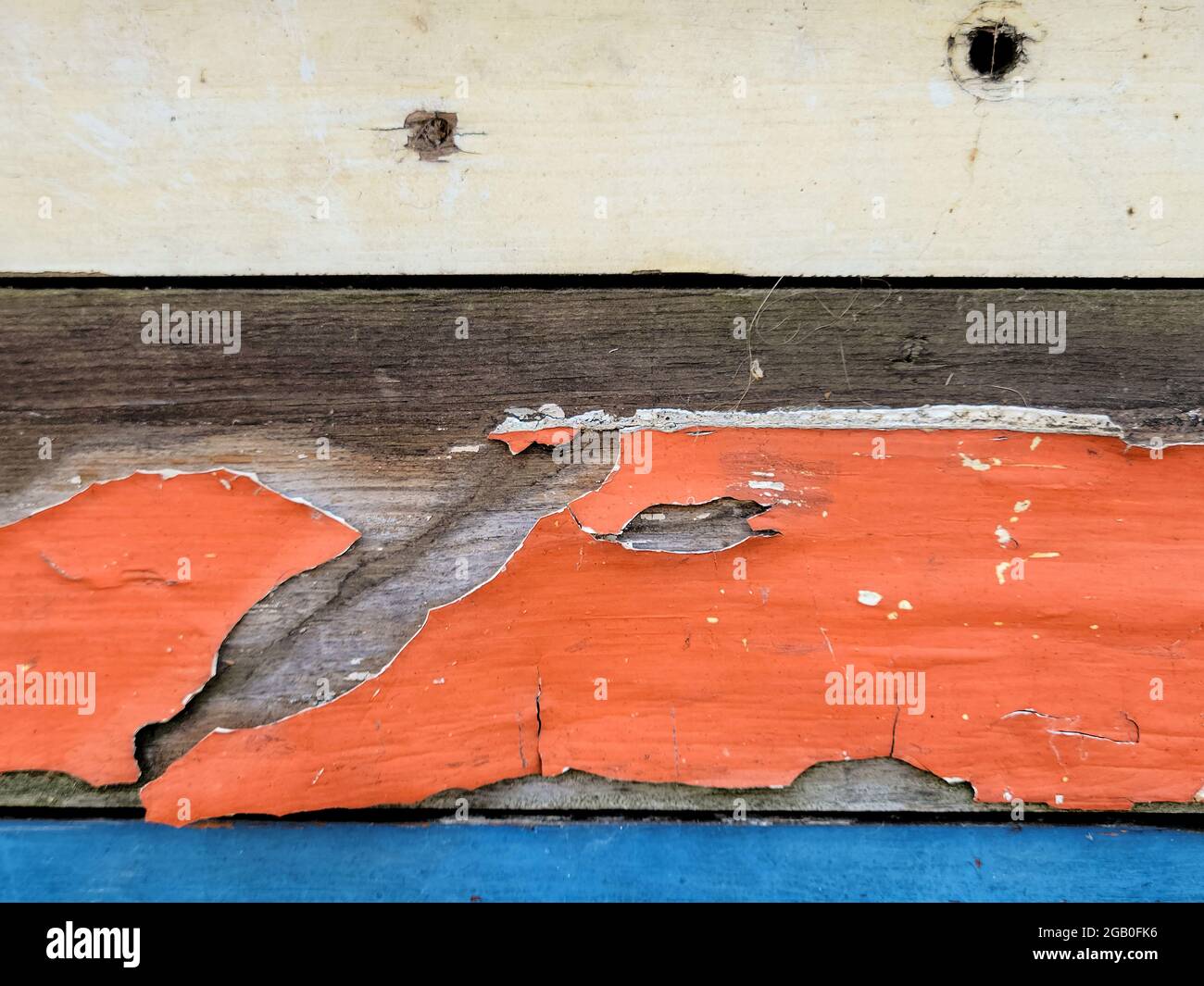 Peeling paint on weathered old wood abstract Stock Photo