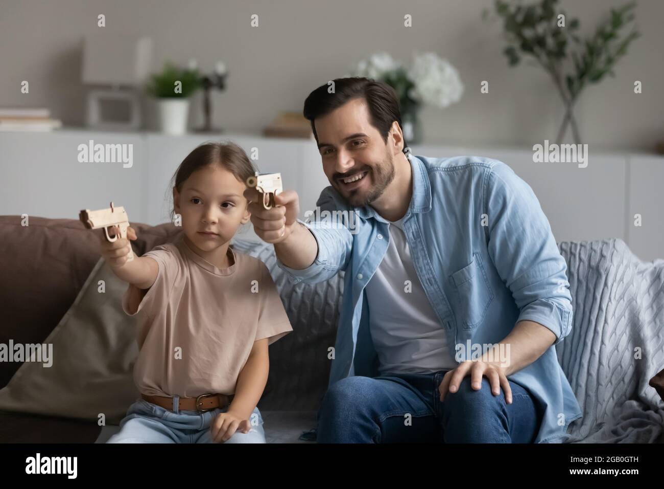 Happy excited dad and daughter kid playing video game Stock Photo