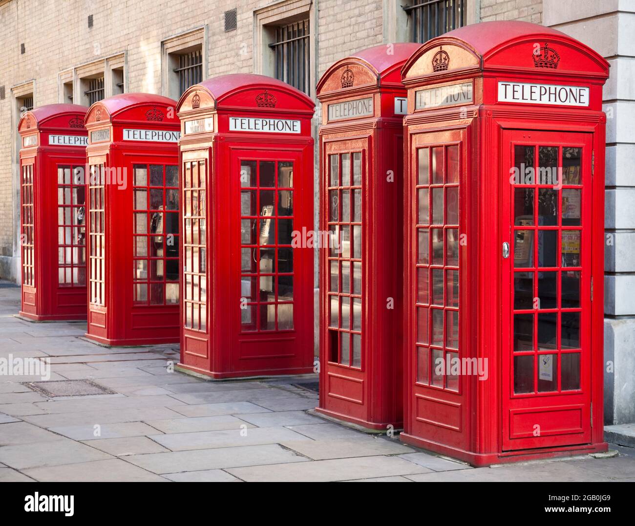 A row of five red telephone boxes in a row in Covent Garden in the West End of central London, England. These are examples of Kiosk No. 2 or K2. Stock Photo