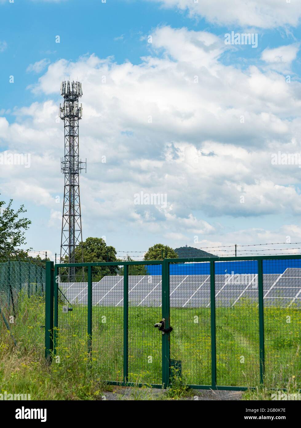 Private solar power plant behind the fence. Solar cells or solar panels ...