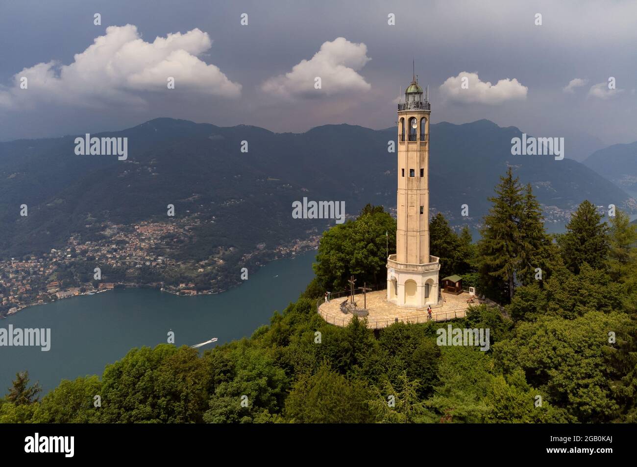 Aerial view of the Faro Voltiano (Volta Lighthouse) in Brunate, with the skyline of Lake Como, green forest and trees near Milan, Italy Stock Photo