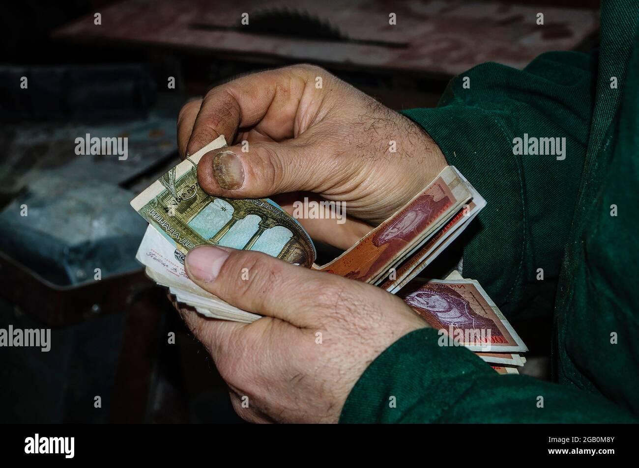 Man counting money, economy concept, allocation of money. Workers hand counting paper money. Stock Photo