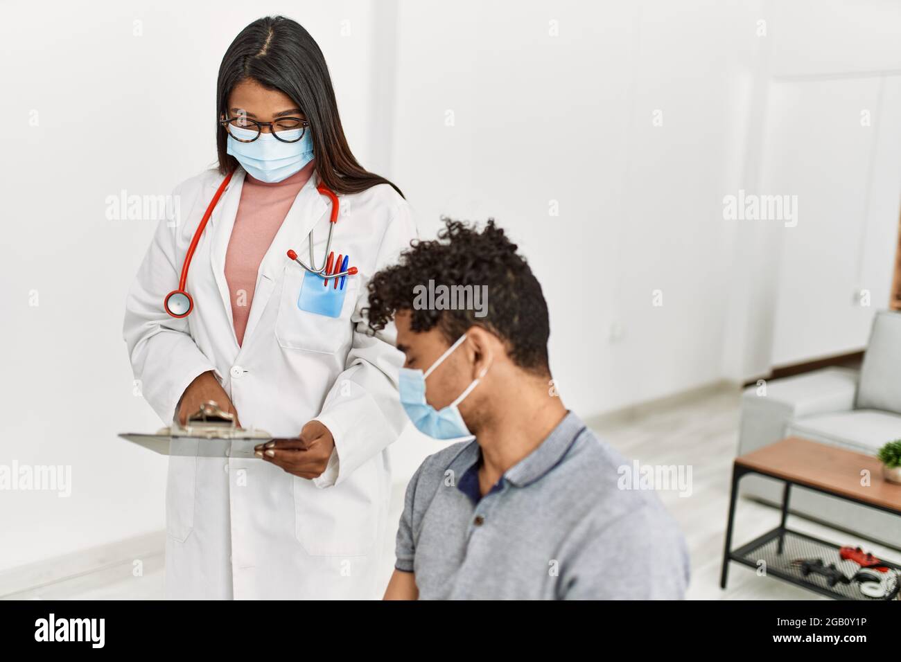 Doctor Using Checklist Young doctor woman reading patient checklist report Stock Photo - Alamy