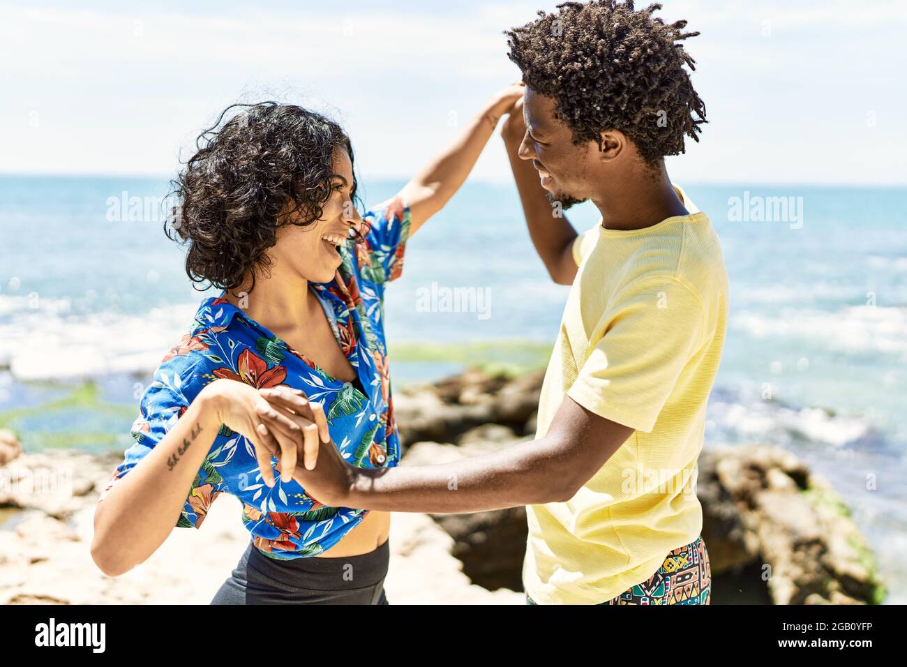 Young beautiful couple smiling happy dancing at the beach Stock Photo ...