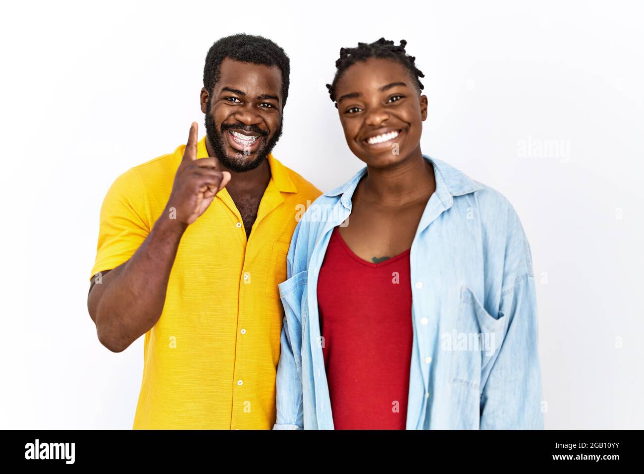 Young african american couple wearing casual clothes showing and ...