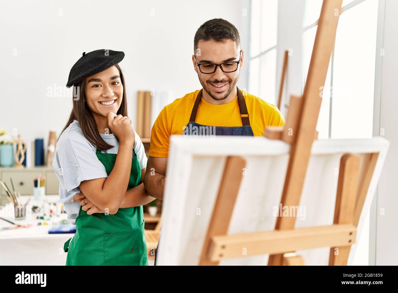 Young hispanic couple smiling happy drawing at art studio Stock Photo ...