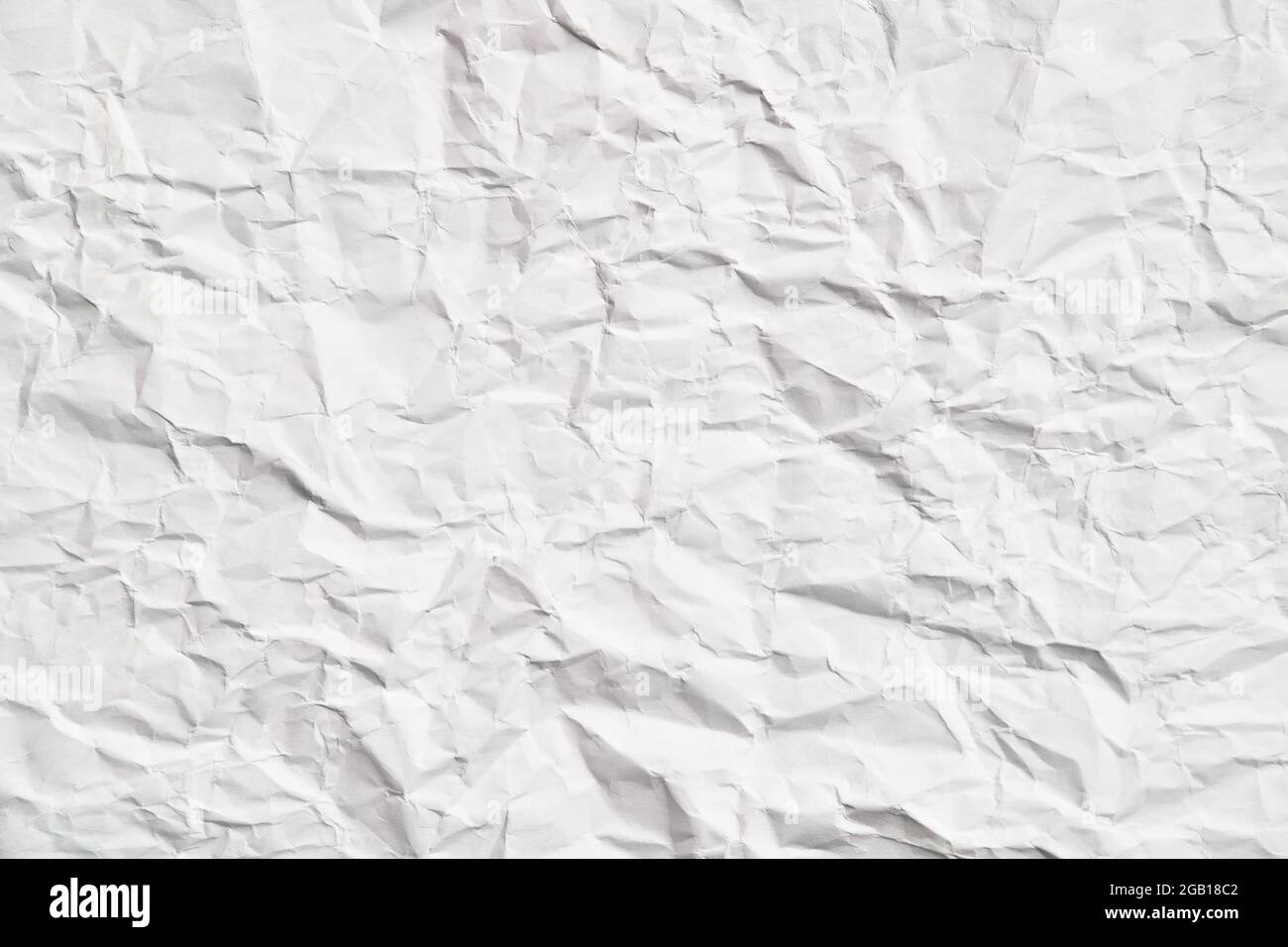 White crumpled paper texture with wrinkles. Damaged and torn sheet