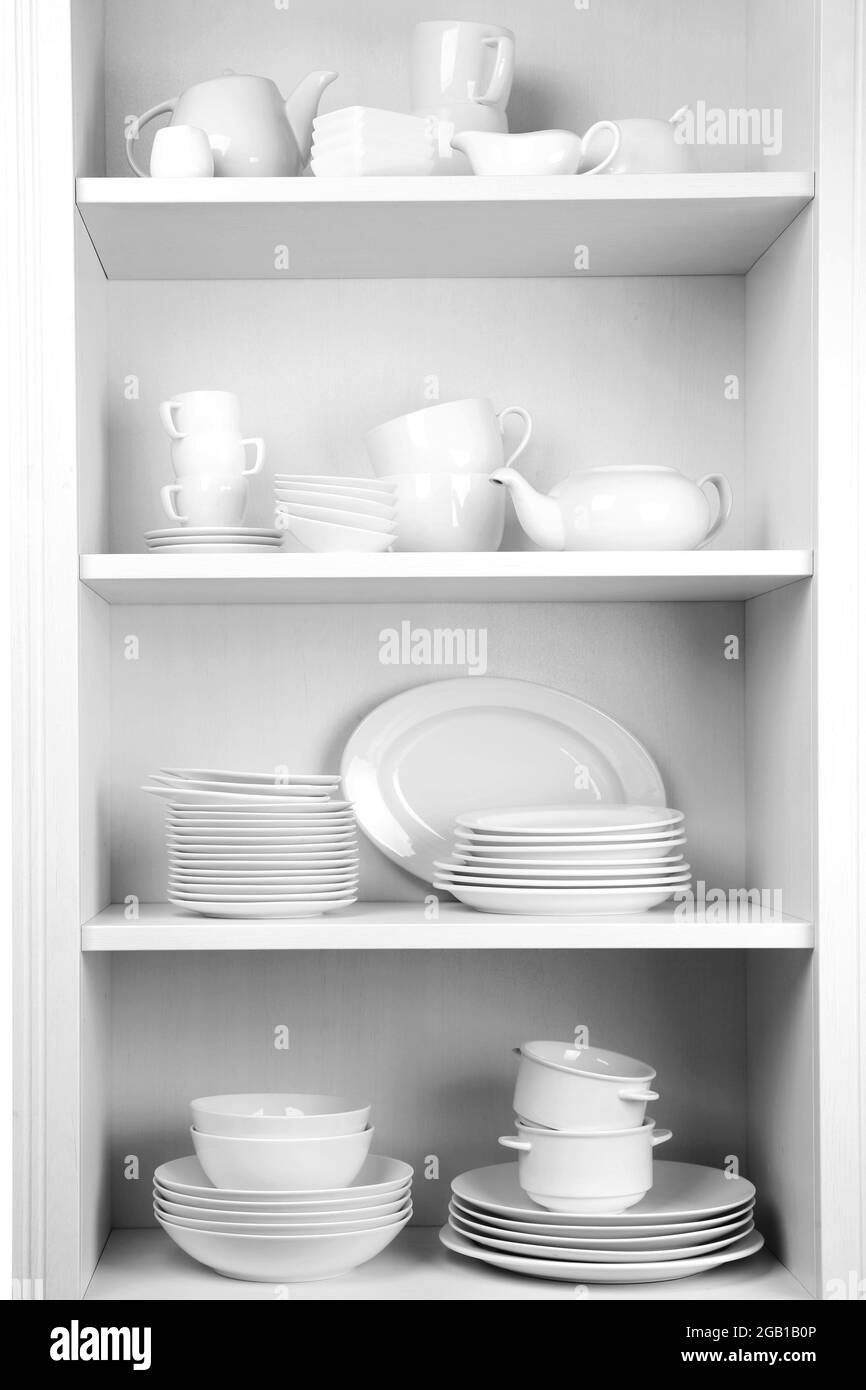 Dishes in cupboard in the kitchen Stock Photo Alamy