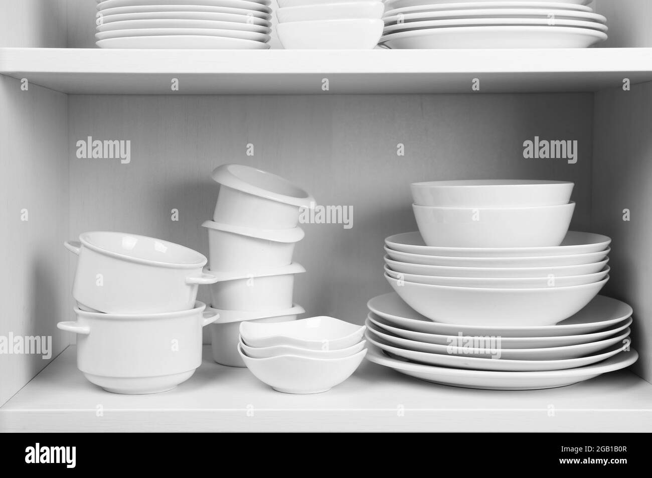 Dishes in cupboard in the kitchen Stock Photo Alamy
