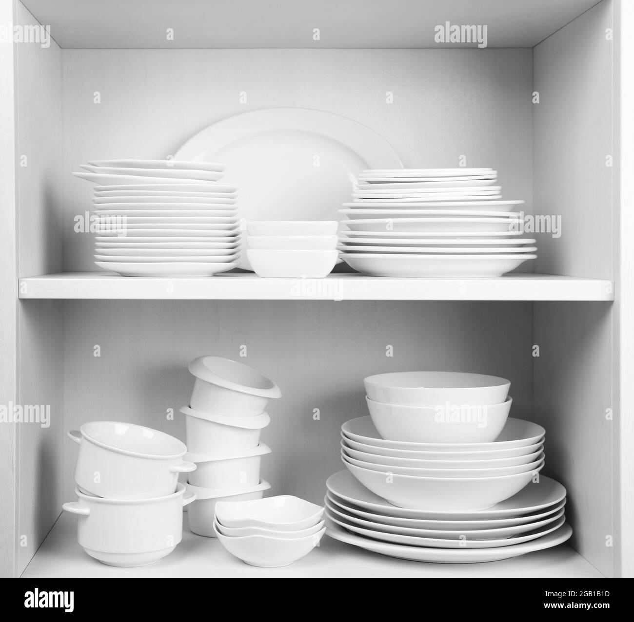 Dishes in cupboard in the kitchen Stock Photo Alamy