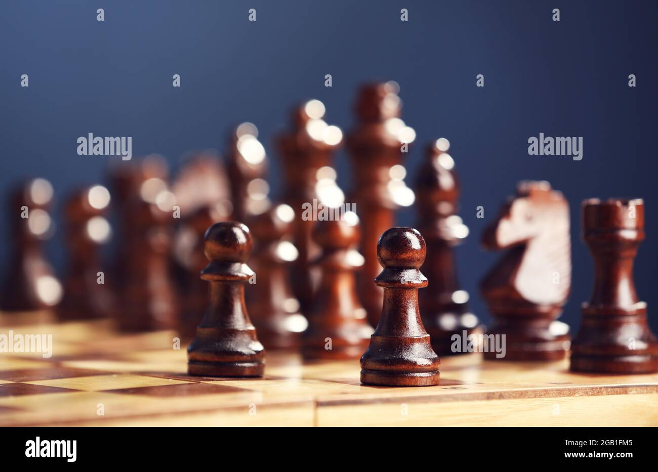 Premium Photo  Chess pieces and game board on dark blue background