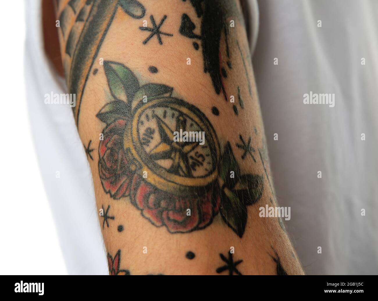 Compass tattoo on male arm over white background Stock Photo - Alamy