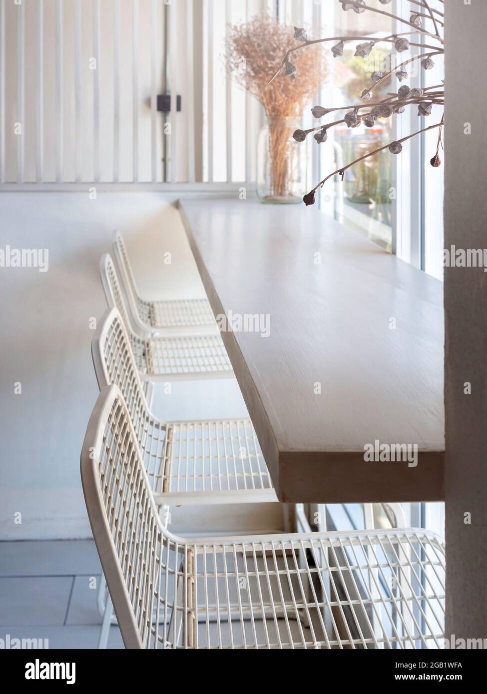 Cafe with simply interior design with a row of empty modern white wire