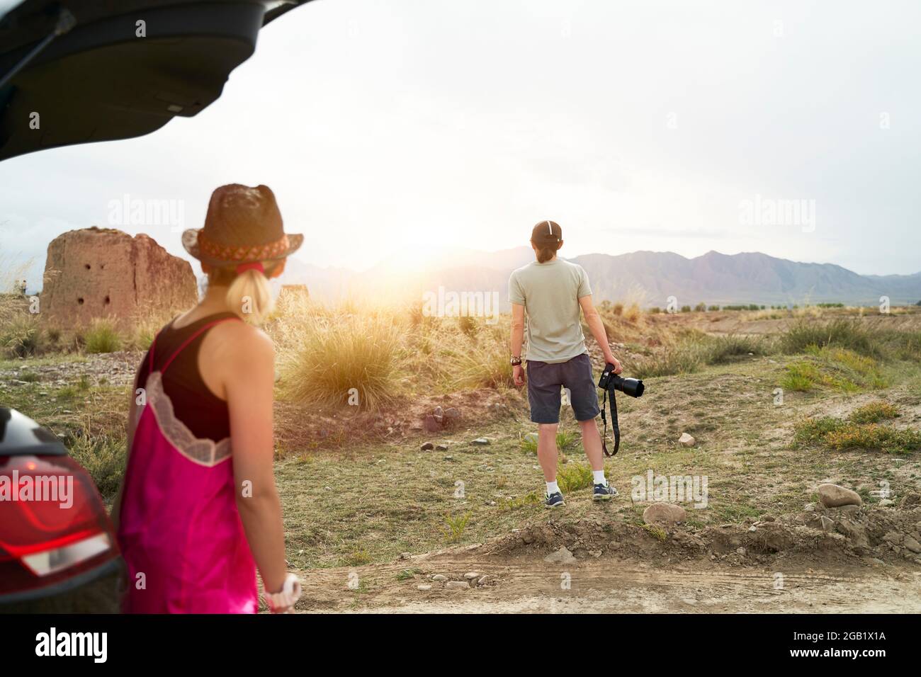 rear view of young asian couple car travelers enjoying the morning sunlight on the road Stock Photo