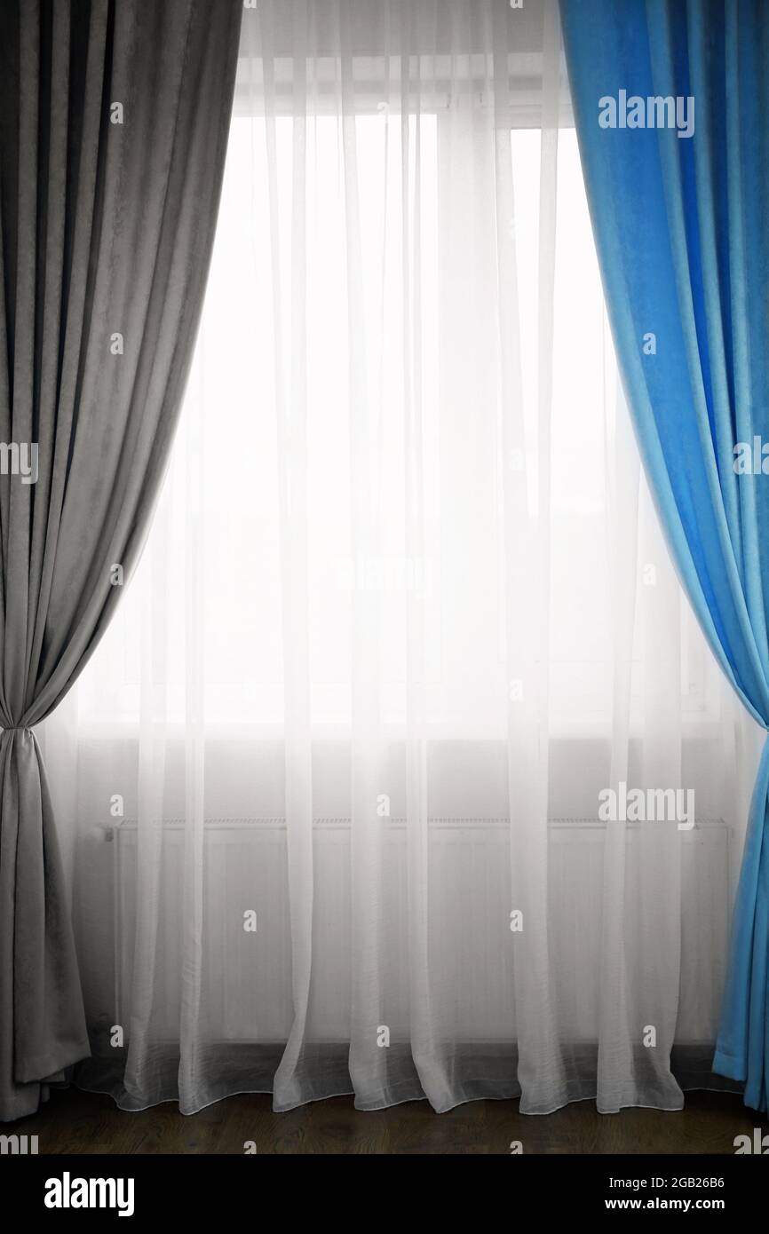 Room window with white, blue and grey curtains Stock Photo Alamy