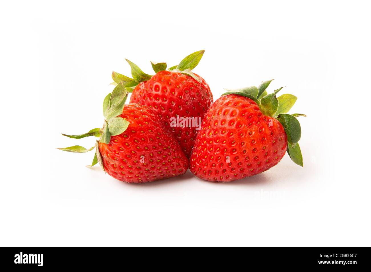 Three strawberries with strawberry leaf on white background Stock Photo ...