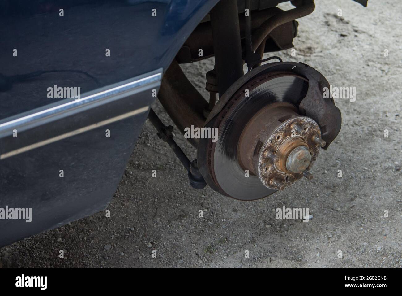 Removal of front wheel bearing on a passenger car. Dirty loud and rusty