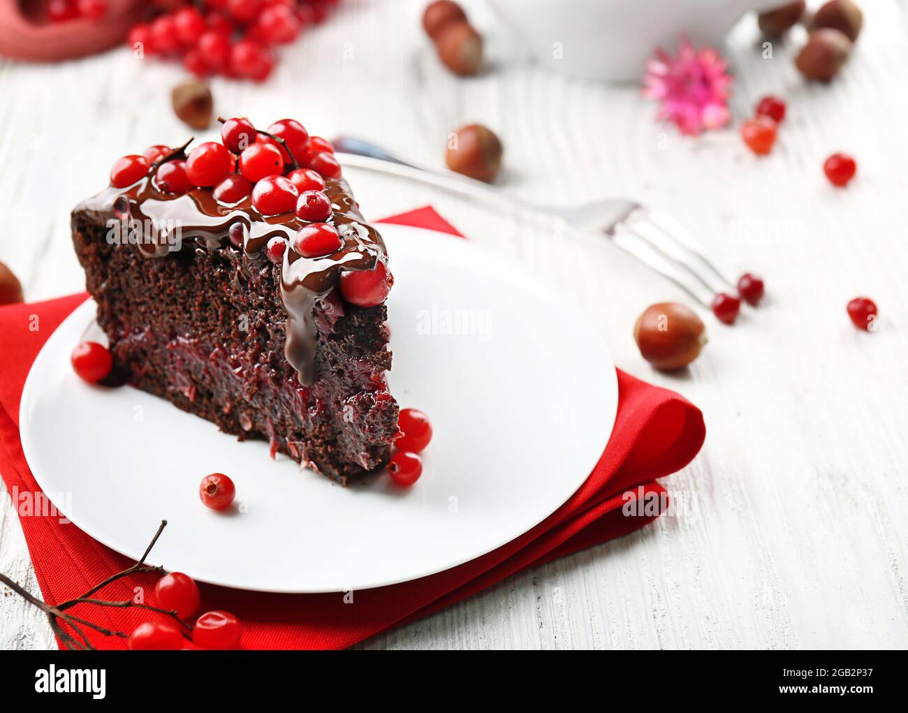 Piece Of Chocolate Cake With Cranberries On Plate With Nuts On Wooden Table Closeup Stock Photo Alamy
