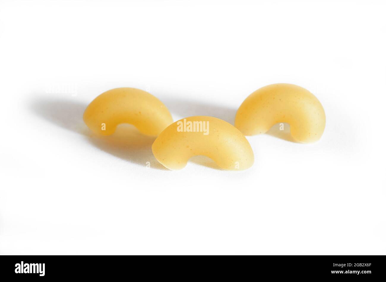 Three macaroni horns isolated on a white background.  Stock Photo