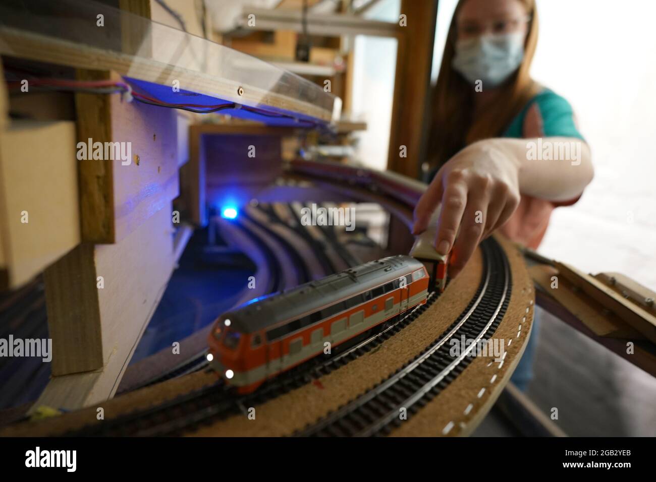 Hamburg, Germany. 05th July, 2021. Ariana Jäger pushes a stalled train on the tracks in Knuffingen in Miniatur Wunderland. The trained sign and light advertising manufacturer has been working at Miniatur Wunderland for one and a half years. (to dpa 'Inspector at Miniatur Wunderland: 'There's always something going on somewhere!') Credit: Marcus Brandt/dpa/Alamy Live News Stock Photo