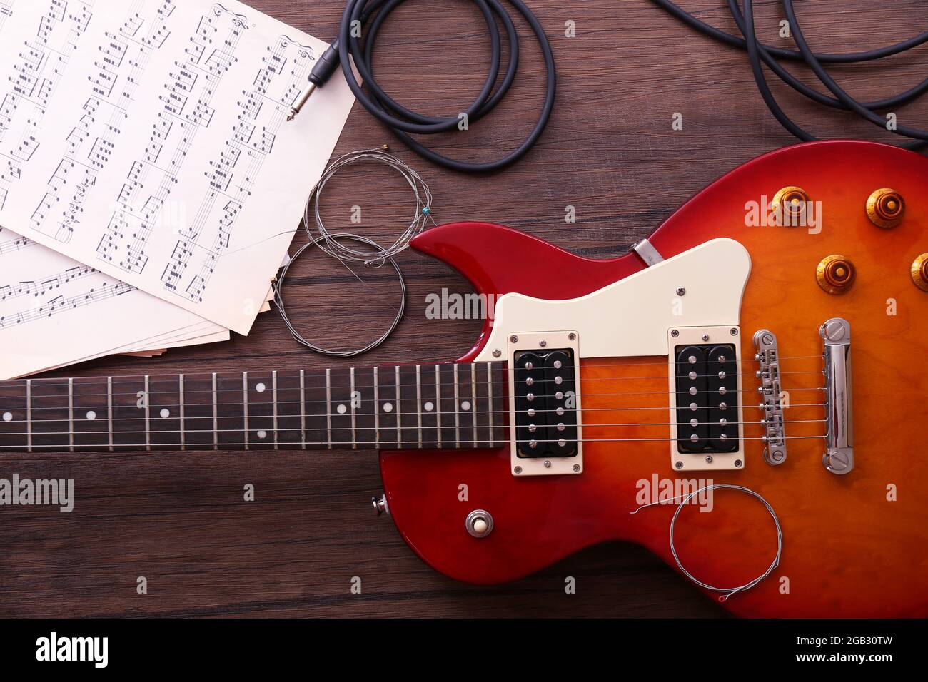 Electric guitar with springs and notes on wooden background Stock Photo ...