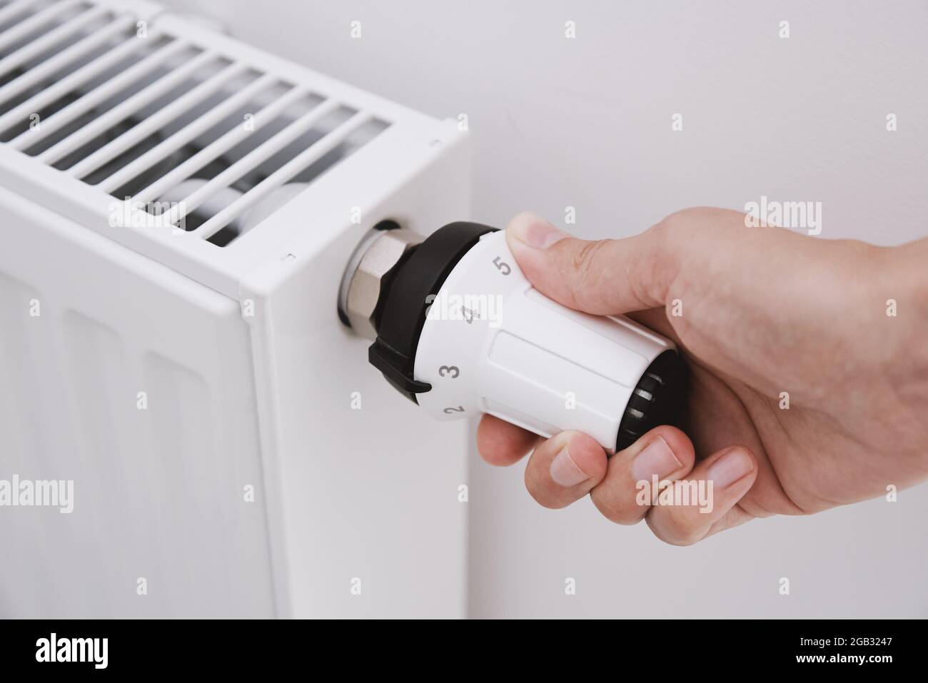 Heat radiator knob. Woman hand adjusting temperature on heating radiator Stock Photo Alamy