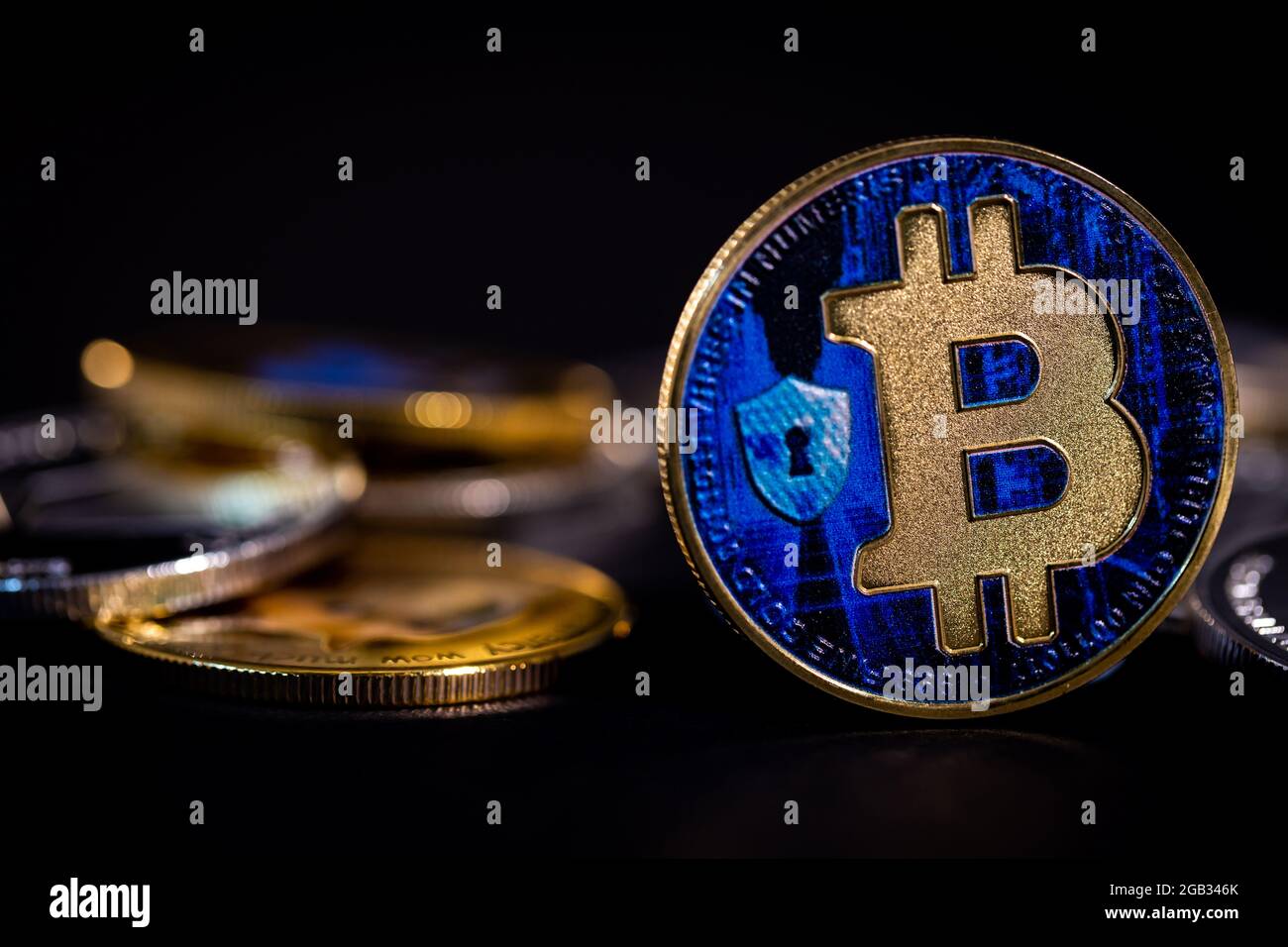 Bitcoin tokens amongst other cryptocurrency coins Stock Photo