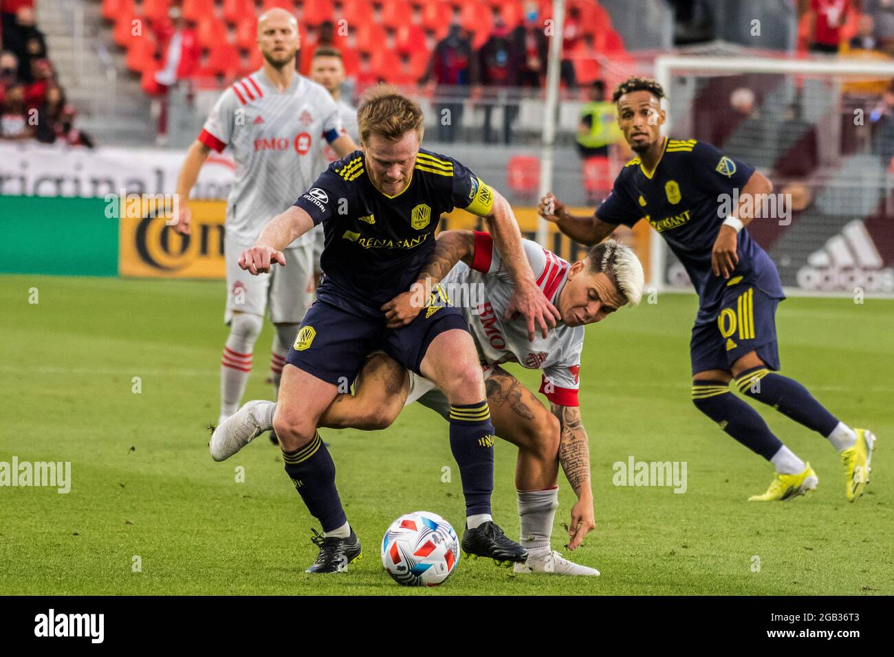 Toronto, Canada. 01st Aug, 2021. Yeferson Soteldo (30) and Dax McCarty (6)  are seen in action during the MLS football match between Toronto FC and  Nashville SC at BMO Field stadium. (Final