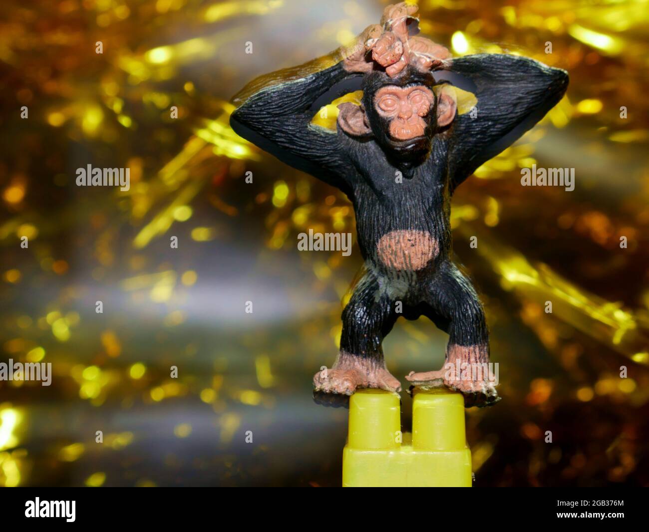 Plastic toy monkey presented with fire sparkle presented for commercial image. Stock Photo