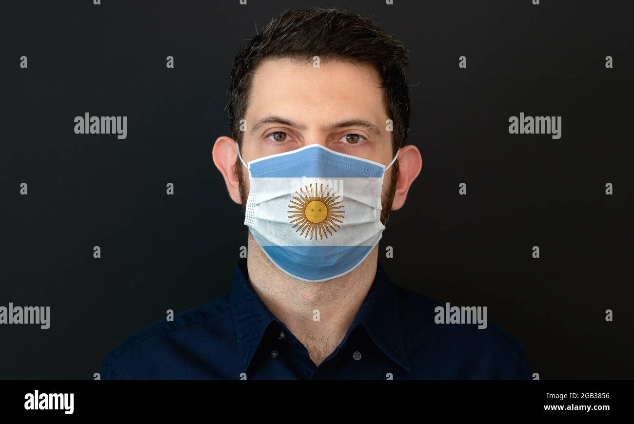 Man wearing Argentinian flag protective medical face mask. He looks ...
