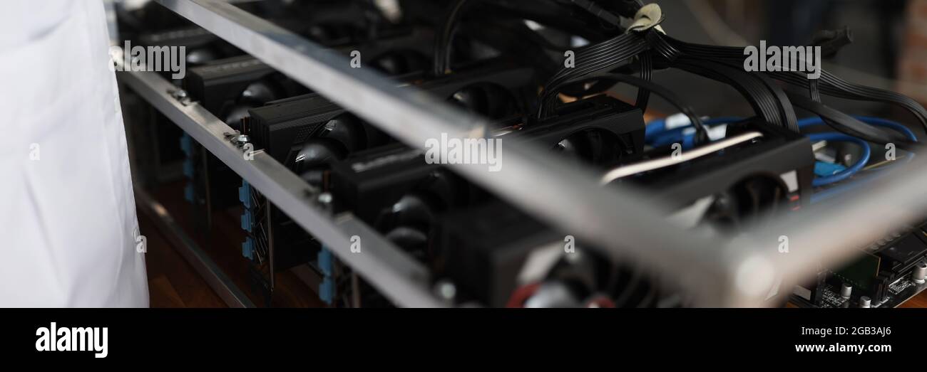 Master checking cryptocurrency mining rig using graphic cards closeup Stock Photo