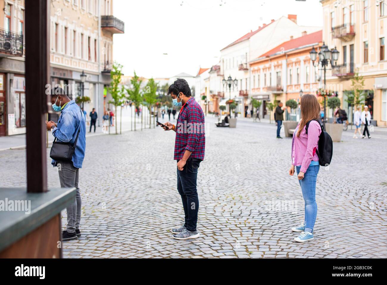 People in masks stand queue keeping social distance Stock Photo - Alamy